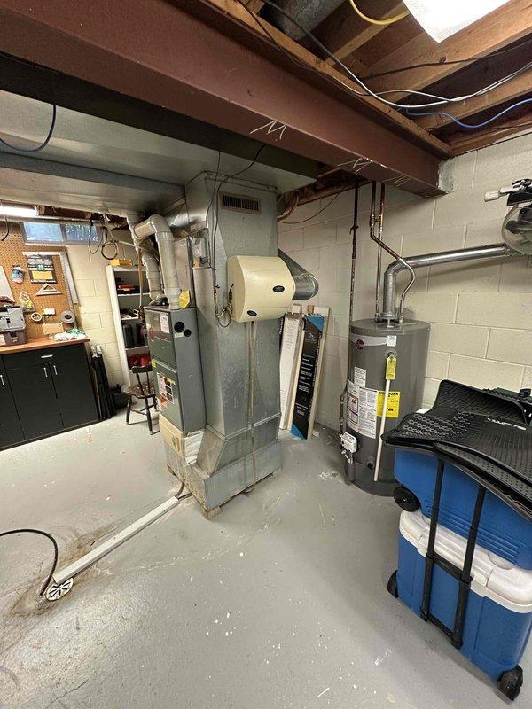Conducted on-site assessment for HVAC system replacement in residential basement. Evaluated existing 25-year-old natural gas furnace and air conditioning system, both currently operational but nearing end of service life. Documented equipment locations, existing ductwork configuration, electrical connections, and outdoor condenser placement. Provided comprehensive replacement estimate for complete heating and cooling system upgrade.