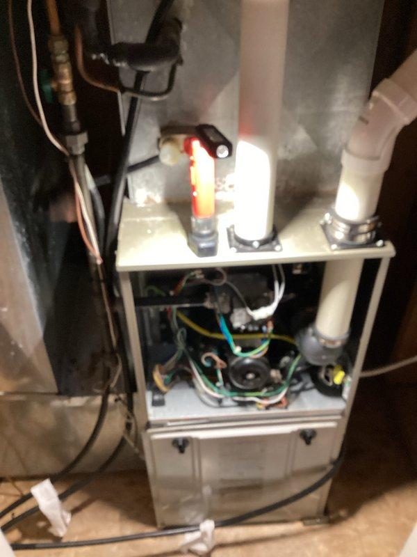 # HVAC Furnace Tune-Up and Combustion Analysis

Performed comprehensive tune-up and safety inspection on residential natural gas furnace system. Conducted full combustion analysis using calibrated analyzer, confirming optimal performance with 94.9% efficiency and safe carbon monoxide levels at 19 PPM. Inspected burner assembly during active operation, verified proper ignition sequence and flame characteristics with hot surface igniter glowing appropriately. 

Examined gas valve operation, electrical connections, and control wiring throughout cabinet sections. Verified condensate drainage system and PVC venting connections for proper installation and function. Inspected blower compartment, ductwork connections, and refrigerant line routing. All components operating within manufacturer specifications with no immediate safety concerns identified.