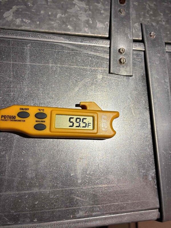 Completed comprehensive tune-up service on commercial furnace and air conditioning system, including installation of Air Bear 20x25x5 filter. Performed diagnostic testing with digital multimeter showing 546.0 reading on system components, and verified temperature measurements at 59°F using precision thermometer to ensure proper system operation and performance standards.