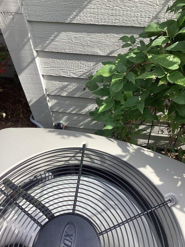 Completed full installation of new air conditioning system and evaporator coil with 24-foot refrigerant line set connecting outdoor condensing unit to indoor air handler. Modified and raised existing ductwork in basement mechanical room to accommodate new equipment configuration. Coordinated with licensed electrician for proper electrical connections and obtained necessary permits for installation compliance. Installed Carrier-branded indoor unit in basement alongside existing water heater, ensuring proper clearances and accessibility for future maintenance. Positioned outdoor condensing unit on exterior pad adjacent to house foundation with appropriate clearance from structure and landscaping. Verified all refrigerant connections, tested system operation, and confirmed proper airflow through modified duct system. System commissioned and operating to manufacturer specifications.