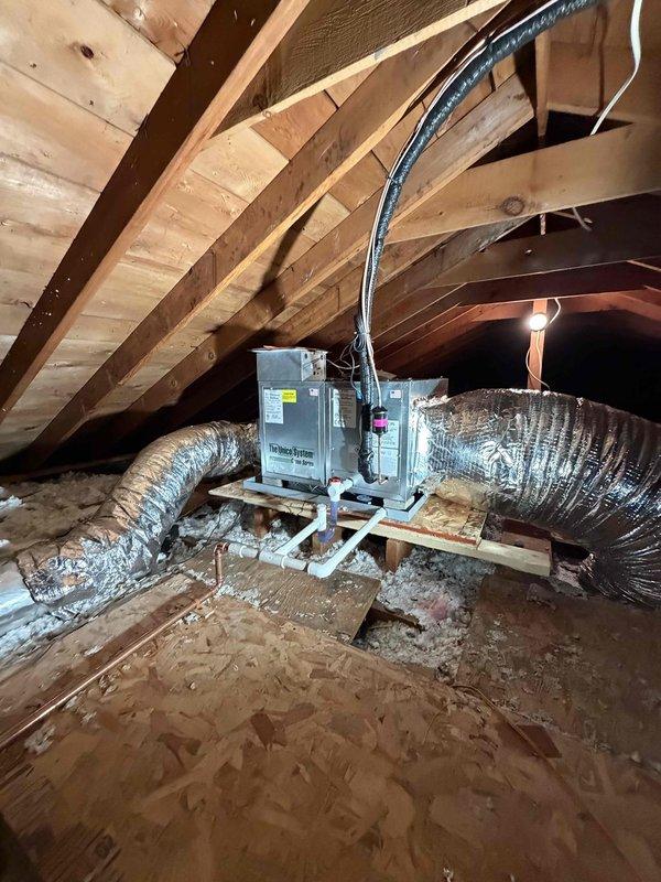 # HVAC Air Handler Installation

Completed installation of Unico air handler system in attic space, including proper mounting on platform, connection of flexible ductwork runs, and electrical conduit installation. System was tested and charged with R410A refrigerant, with final readings showing 68.6 psi low pressure, 245.6 psi high pressure, 63.2°F superheat, and 23.0°F subcooling, confirming proper system operation.

## Work Performed

Installed new Unico air handler unit in residential attic space on constructed wooden platform with adequate clearance for service access. Secured unit to platform using appropriate fasteners and leveling to manufacturer specifications. Connected flexible insulated ductwork to air handler, routing supply and return ducts through attic space to designated zones. Sealed all duct connections with mastic and secured with approved fasteners to prevent air leakage.

Ran electrical conduit from main panel to air handler location, ensuring proper wire gauge for