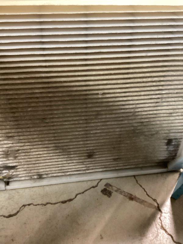 Completed furnace and air conditioning tune-ups on dual HVAC system. Inspected Space-Gard air filtration unit, furnace blower assembly, electrical connections, and venting components. Noted significant contamination on evaporator coil fins with dark staining in lower sections and visible cracks in drain pan indicating age-related deterioration that may require future attention.