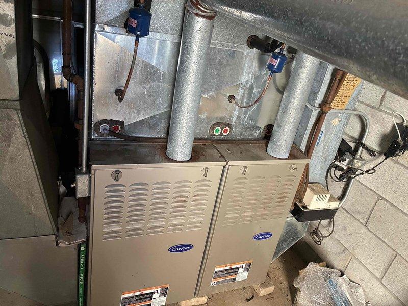 Responded to no cooling complaint on dual Carrier furnace HVAC system. Upon inspection, discovered severely corroded exhaust pipe requiring replacement due to structural deterioration and compromised venting integrity. Documented existing conditions with photos showing rust damage and oxidation on copper piping and ductwork components. Coordinated with dispatch for scheduling and customer communication regarding necessary repairs to restore safe system operation.
