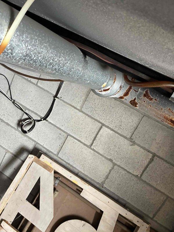 Responded to no cooling complaint on dual Carrier furnace HVAC system. Upon inspection, discovered severely corroded exhaust pipe requiring replacement due to structural deterioration and compromised venting integrity. Documented existing conditions with photos showing rust damage and oxidation on copper piping and ductwork components. Coordinated with dispatch for scheduling and customer communication regarding necessary repairs to restore safe system operation.
