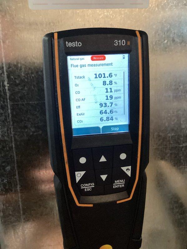 Completed comprehensive furnace tune-up including full system inspection and combustion analysis. Flue gas testing with Testo 310 II analyzer confirmed optimal performance with efficiency at 93.7%, oxygen at 8.8%, carbon monoxide at 11 ppm (19 ppm air-free), and carbon dioxide at 6.84%. Inspected and serviced condensate drain system components, ensuring proper drainage and secure mounting of drain line assembly.