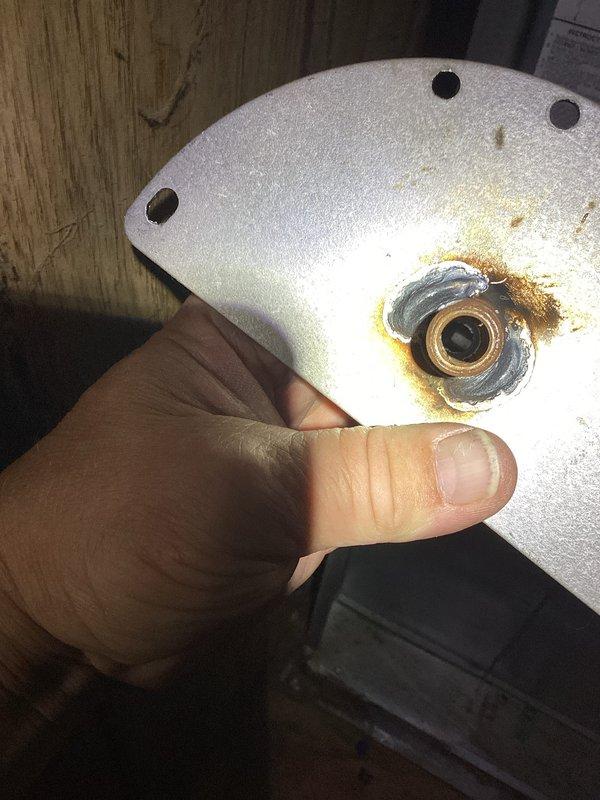 Responded to no heat call and diagnosed failed inducer motor assembly. Motor bearing showed significant heat damage and discoloration, causing complete failure and preventing furnace operation. Removed damaged inducer motor housing, documented extent of thermal damage to mounting bracket and bearing assembly, and prepared unit for replacement part installation to restore heating functionality.