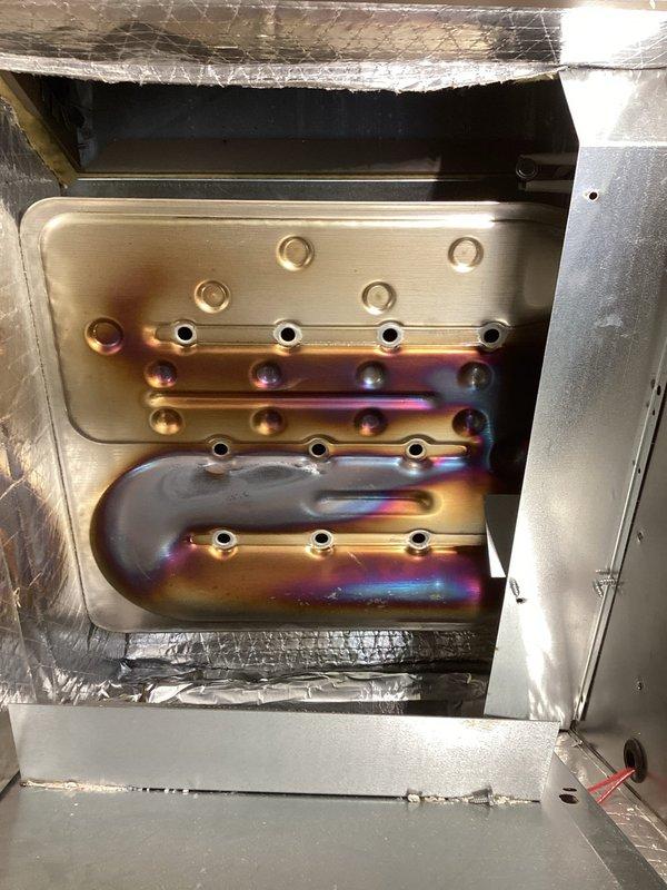 Completed Magic Pack tune-up service during scheduled arrival window. Performed comprehensive system inspection and documentation, including detailed photographic assessment of heat exchanger assembly showing normal operational heat discoloration patterns on serpentine tubing and backing plate. All components verified to be structurally intact and functioning within specifications.