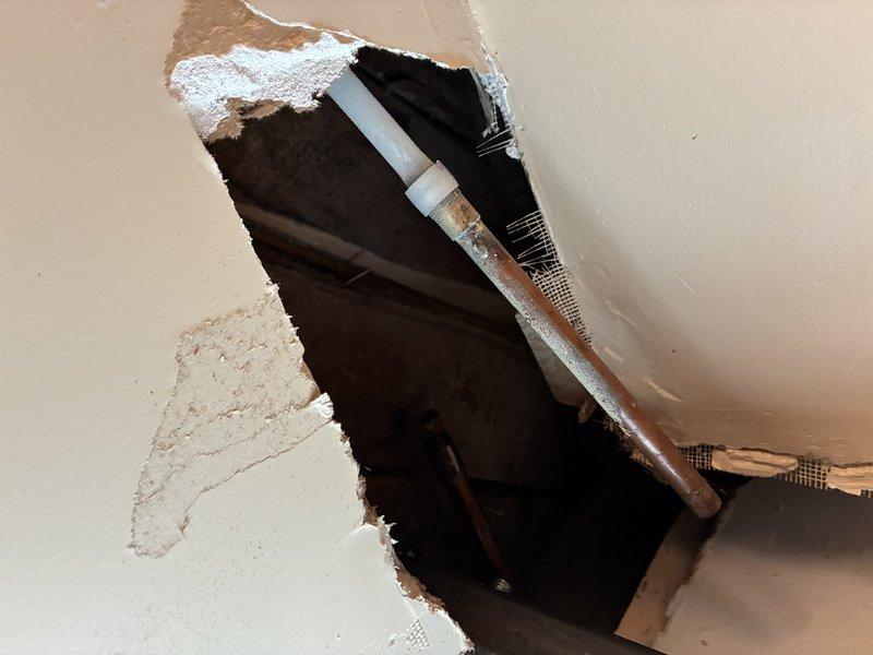 Responded to emergency call for burst pipe in basement. Upon arrival, performed diagnostic inspection and located compromised copper supply line behind damaged drywall section. Extensive water damage and staining evident throughout affected cavity area, indicating prolonged leak prior to pipe failure. Assessed structural framing and plumbing configuration, documented damage with photos, and provided customer with repair recommendations including pipe replacement and restoration of water-damaged surfaces.