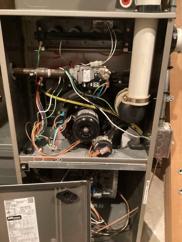 Completed preventative maintenance tune-up on gas-fired HVAC system. Removed access panel to inspect internal components including heat exchanger, blower motors, gas valve assembly, electrical connections, and ductwork. Verified supply air temperature at duct system reading 71.93°F and confirmed proper airflow through metallic ductwork. All mechanical and electrical components inspected and found operating within normal parameters.