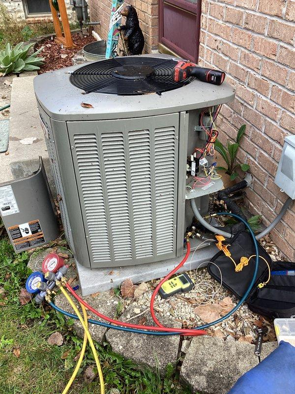 Completed comprehensive tune-up service on residential split HVAC system including furnace and air conditioning condenser unit. Performed refrigerant pressure diagnostics using manifold gauges on outdoor AC unit, inspected electrical connections and junction box wiring at furnace, and verified all components operating within manufacturer specifications.