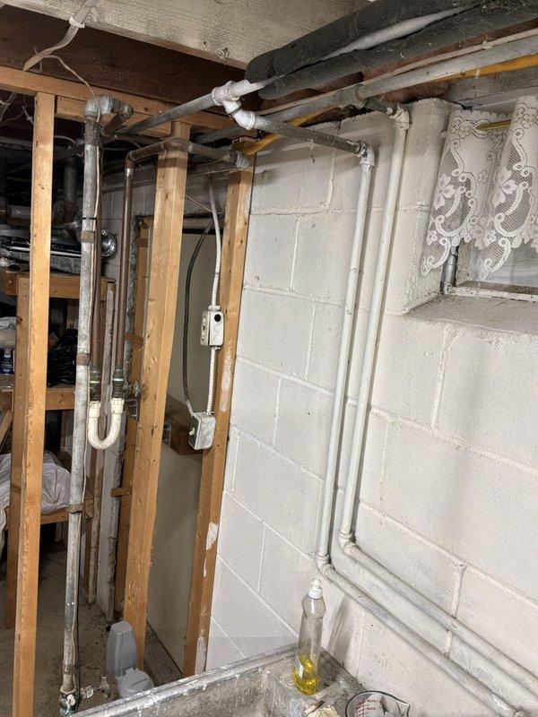 Provided estimate for replacement of main water shut-off valve located in basement utility area. Assessed existing plumbing configuration including water supply lines, shutoff valve accessibility near water heater and furnace equipment, and determined scope of work required for valve replacement to restore proper water system control.