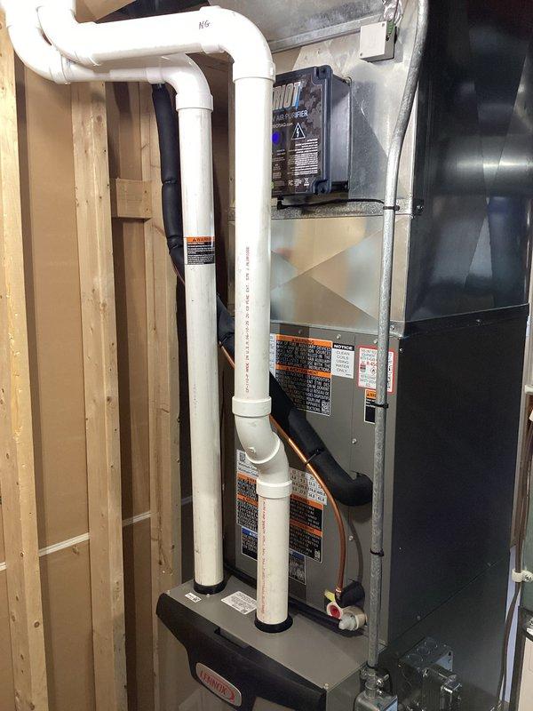 Completed full HVAC system installation including new furnace and air conditioning unit in basement utility area. Reused existing zoning system and ERV to maintain multi-zone climate control capability. Installed Ecobee Premium thermostat for first floor zone and Ecobee Lite thermostat for second floor zone to provide independent temperature management for each level. Coordinated with licensed electrician on-site to ensure proper electrical connections and code compliance for all equipment. Configured PVC venting system with proper drainage routing to floor drain. Connected refrigerant lines and gas piping to new equipment. Mounted furnace on platform base with secure anchoring. Verified all safety controls, labeling, and warning placards properly affixed to equipment. System tested and operational upon completion.