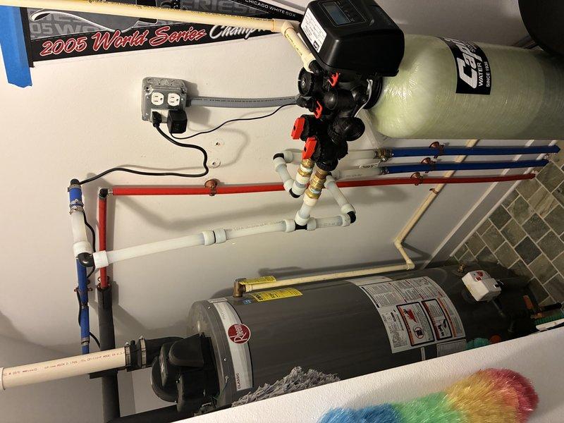 Installed and routed new water supply lines from the tanked water heater throughout the property. Ran blue PEX piping through crawl space area, securing lines to wooden framing with appropriate fasteners and utilizing red compression fittings at connection points. Connected distribution piping to existing water heater system, which includes pressure tank, well pump assembly, and associated shut-off valves. All water lines were properly supported and routed to supply fixtures as required, ensuring adequate flow and pressure throughout the system.