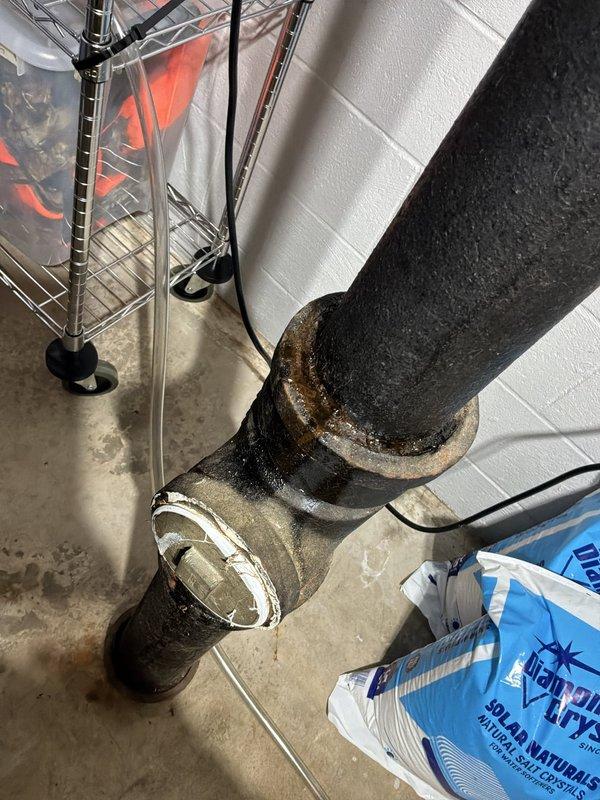Completed comprehensive whole home plumbing inspection of residential property. Evaluated sump pump system in basement utility area, including PVC discharge piping, check valve operation, and pit condition. Inspected HVAC condensate drain line and connections, noting corrosion and mineral deposits on metal fittings that may require future attention to prevent potential leakage.