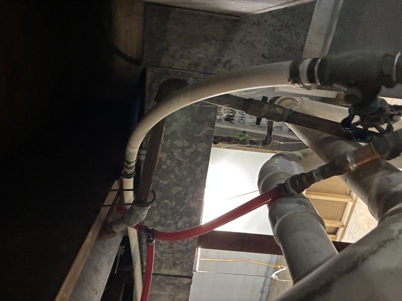 Conducted on-site assessment for water heater replacement in basement utility area. Evaluated existing water heater unit showing signs of age and potential moisture exposure issues, with surrounding area displaying significant water damage and deterioration to walls and ceiling surfaces. Customer requested new unit be elevated off ground level to prevent rust and corrosion from floor moisture contact. Documented current installation configuration including connected PVC piping, ductwork connections, and existing mechanical systems layout. Provided estimate for replacement water heater installation with elevated platform mounting to address moisture concerns and extend equipment lifespan.
