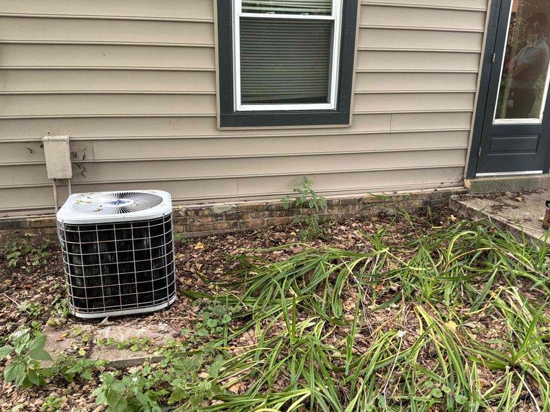 Completed estimate for full HVAC system replacement including natural gas furnace located in basement and outdoor air conditioning condenser unit. Customer requested second opinion on existing estimate for comparison. Evaluated current equipment configuration, assessed installation requirements, and documented existing system setup including thermostat controls and outdoor unit placement. Photographed exterior AC unit on concrete pad near foundation and interior wall-mounted thermostat and control devices to support equipment specifications and replacement recommendations.