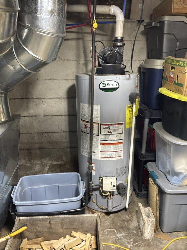 Completed comprehensive whole home plumbing inspection of residential property. Evaluated and documented all visible plumbing systems including water supply lines, drainage systems, fixtures, and mechanical equipment. 

Inspected basement utility area containing water pressure system with blue WE-branded pressure tank connected via blue PEX supply lines and copper piping with brass fittings and valves. Verified pressure gauge readings and assessed condition of tank connections and fittings. Examined wall-mounted Impression digital control panel and associated white cylindrical storage tank for proper operation and signs of wear.

Evaluated AO Smith water heater installation including top-mounted black pump assembly, electrical connections, and gas supply lines. Inspected copper and flexible metal tubing connections for leaks or corrosion. Assessed water heater drain pan installation and verified proper placement. Checked all visible piping including white PVC drainage lines and metalli