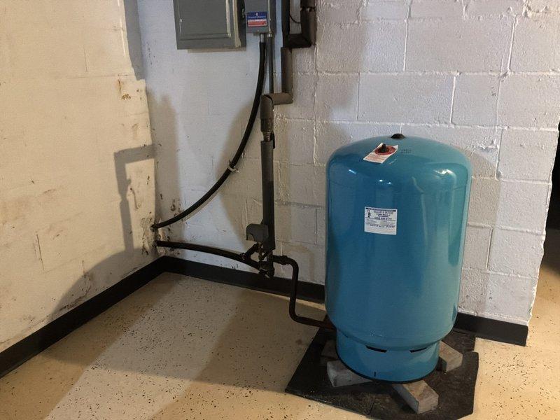 Completed comprehensive whole home plumbing inspection of residential property. Evaluated all accessible plumbing systems including water supply lines, drainage systems, sump pump operation in basement utility area, and pressure tank functionality. Inspected white PVC drainage piping, mounting brackets, and sump pump installation with electrical connections in lower level, confirming proper operation and clearances. Assessed pressure tank system including gauge readings, connections, black supply piping, flexible tubing, and associated electrical control panel. All components photographed and documented for service records, with systems found to be operational at time of inspection.