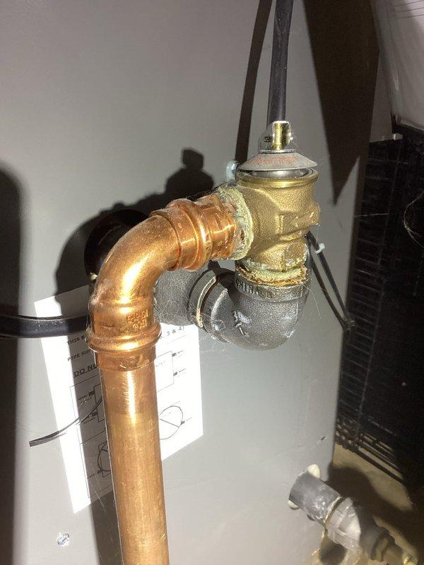 # HVAC Service Report

Responded to service call for leaking pressure relief valve on residential boiler system. Upon inspection, identified active leak at pressure relief valve connection point on copper supply piping. Valve assembly showed signs of deterioration at brass fitting connection. Replaced faulty pressure relief valve with new unit, ensuring proper torque specifications and seal integrity. Tested system operation under pressure to verify leak was eliminated. Confirmed all connections secure and system operating within normal parameters. No further leaks detected upon completion of repair.