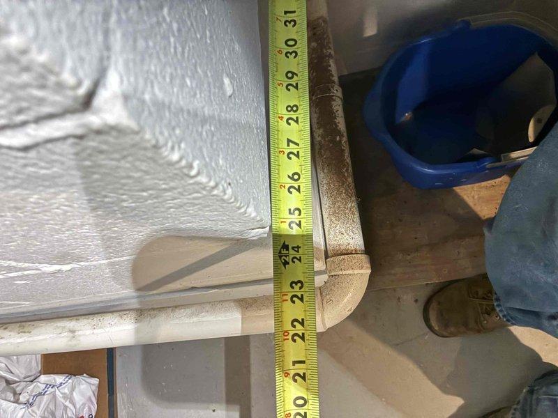 Returned to address inspector's corrections on recent HVAC installation. Documented clearance measurements from front of furnace to wall and replaced temporary cardboard flap on return air plenum with proper sheet metal covering per code requirements.