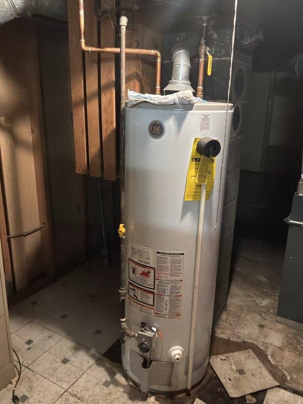 Conducted on-site evaluation for water heater replacement in residential basement utility area. Assessed existing General Electric water heater unit, documented current installation including copper supply piping, venting configuration, and connection points. Customer previously received quote and is now ready to proceed with replacement. Coordinated arrival time and confirmed scope of work for new water heater installation.