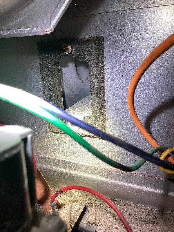 Responded to service call for boiler experiencing multiple issues including water leaks from burst pipe, inadequate heating distribution with only upper level receiving heat, and overall system malfunction. Performed diagnostic inspection of boiler unit and heating components, documenting condition of heat exchanger elements showing significant corrosion, mineral deposits, and uneven wear patterns indicating compromised combustion chamber integrity. Examined wiring connections and control components, noting configuration of electrical connections and access panels for further assessment of heating zone distribution problems.