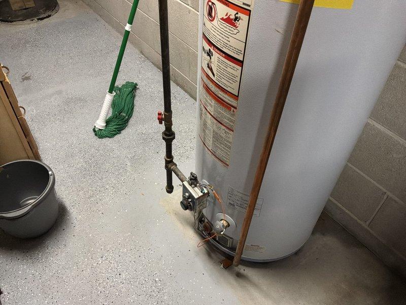 Conducted estimate for replacement of 16-year-old Kenmore model 153.339762 water heater with 48-gallon capacity that is actively leaking. Customer requested upgrade to 60-gallon unit to accommodate increased hot water demand. Assessed existing installation including copper supply lines, exhaust venting, pressure relief valve configuration, and floor drainage. Documented current unit condition with photographs showing leak evidence and utility room layout. Provided recommendations for new water heater installation including proper venting requirements, code-compliant pressure relief valve discharge piping, and expansion tank evaluation.