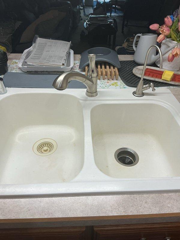 Responded to service call for kitchen faucet malfunction and dishwasher water supply issues. Upon arrival, performed diagnostic assessment of the kitchen plumbing system. Identified that the existing kitchen faucet was failing and causing inadequate water flow, which was subsequently affecting the dishwasher's ability to fill properly during its cycle. The dishwasher was shutting down mid-cycle due to insufficient water pressure and volume reaching the appliance. Recommended replacement of the kitchen faucet to restore proper water delivery to both the sink and connected dishwasher supply line. Documented existing conditions with photographs of the kitchen sink area and exterior hose bib for service records.