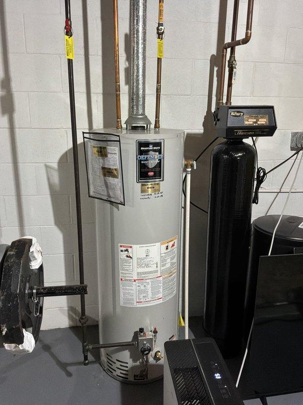 Provided estimate for tankless water heater replacement to upgrade from existing 22-year-old 50-gallon conventional storage tank unit. Assessed current installation including water heater connections, existing copper and galvanized piping, water softener system integration, and venting requirements for potential tankless conversion.