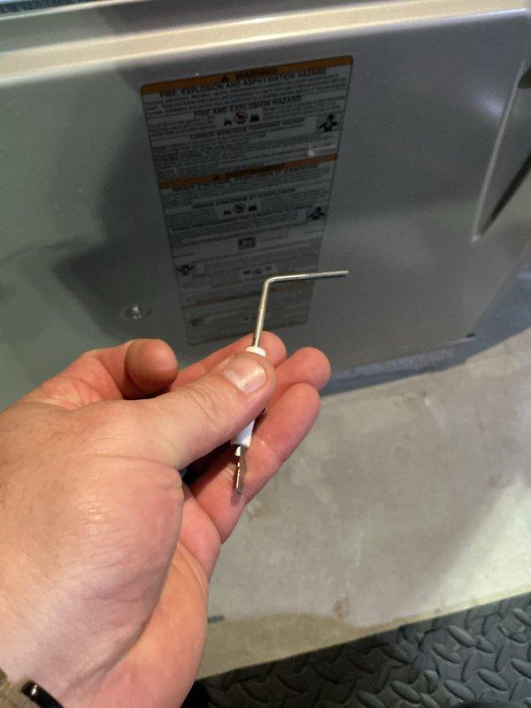 Completed prepaid heating maintenance visit on Carrier system. Verified thermostat operation displaying 68° room temperature with proper communication to equipment. Inspected and documented bent copper refrigerant line requiring attention during service call.