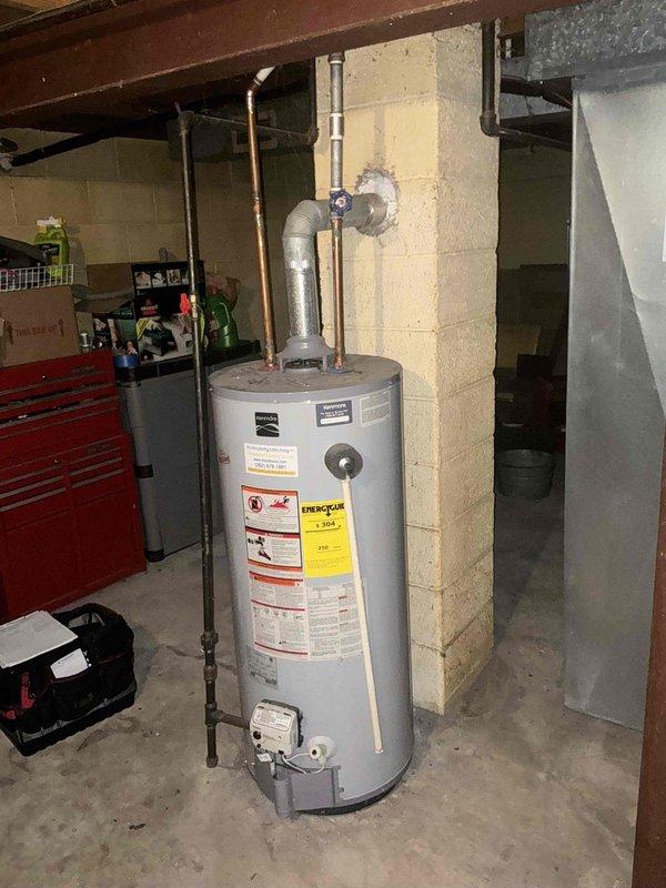 Responded to service call for non-functioning water heater in residential basement utility room. Conducted on-site assessment of existing short-style water heater with standard copper supply lines and PVC drainage configuration. Documented current installation including plumbing connections, venting system, and clearance specifications. Provided comprehensive replacement estimate for new water heater unit with comparable capacity and dimensions suitable for existing space constraints.