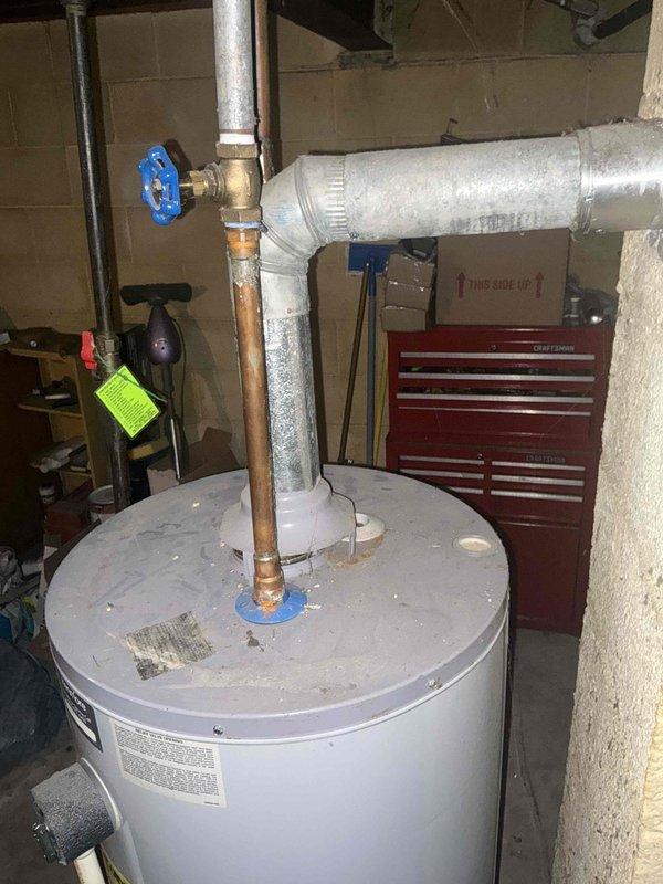 Responded to service call for non-functioning water heater in residential basement utility room. Conducted on-site assessment of existing short-style water heater with standard copper supply lines and PVC drainage configuration. Documented current installation including plumbing connections, venting system, and clearance specifications. Provided comprehensive replacement estimate for new water heater unit with comparable capacity and dimensions suitable for existing space constraints.