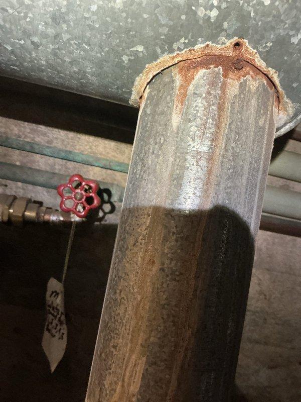 Responded to no heat call for boiler system. Upon arrival, conducted thorough inspection of mechanical equipment and documented existing conditions. Found significant corrosion and rust deterioration on vertical supply piping, with heavy oxidation visible at pipe connections and fittings. Observed water heater expansion tank installed with date marking indicating previous service work. Collected equipment information and photographed corroded components showing advanced deterioration from moisture exposure over time. System evaluation completed and findings documented for further assessment and repair recommendations.
