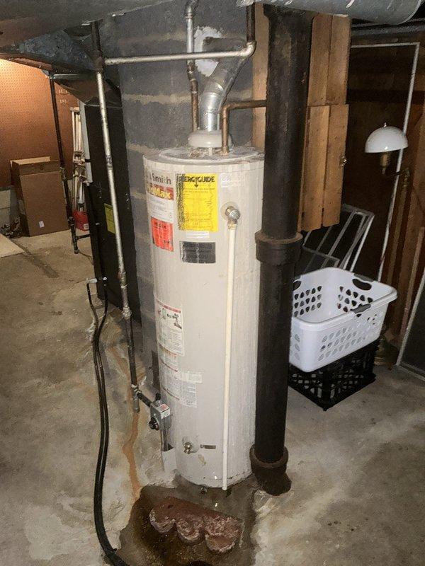 Responded to emergency service call for leaking water heater in residential basement. Upon inspection, found ProMax brand water heater with visible signs of deterioration, water damage, and staining at base indicating active leak. Unit was still operational but compromising safety and efficiency. Documented existing installation including PVC supply connections, metal flue piping, and electrical connections. Assessed surrounding utility area conditions and provided comprehensive estimate for complete water heater replacement including removal of existing unit, installation of new water heater with proper venting, code-compliant piping connections, and disposal of old equipment.