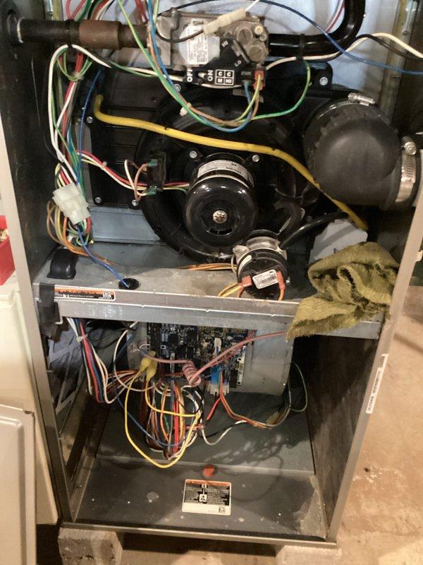 Completed comprehensive heating system tune-up and maintenance on 15-year-old furnace unit. Performed full system inspection including blower motor assembly, belt tension verification, electrical connections, and control module testing. Cleaned ductwork system and documented existing condensation on metallic plenum, indicating proper humidity levels during heating season. All components operating within manufacturer specifications; system tested and returned to service.