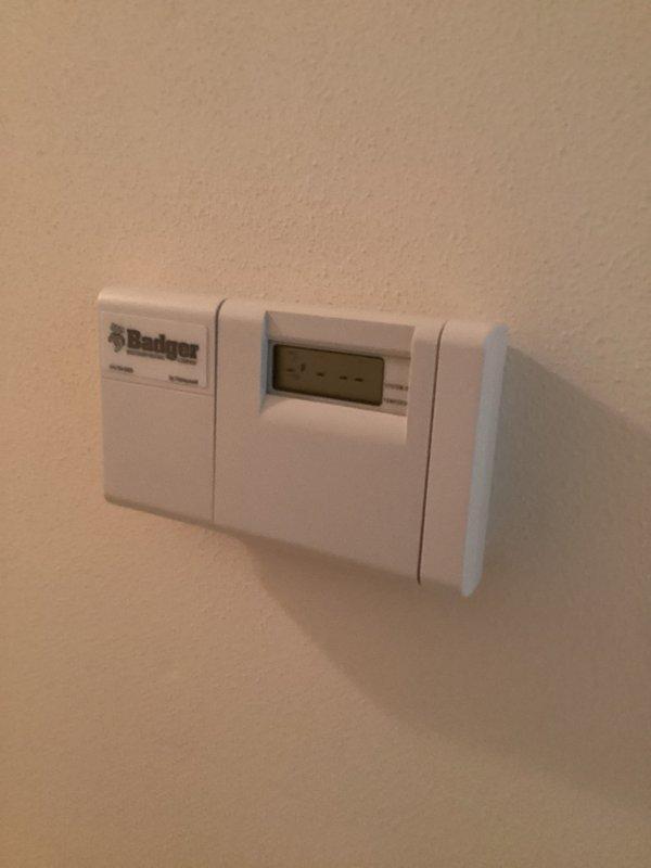 Responded to service call for non-functioning thermostat. Upon arrival, found Badger brand programmable thermostat displaying 59°F with system set to cooling mode in manual operation. Inspected unit, verified display functionality, and assessed thermostat programming and wiring connections to restore proper operation.