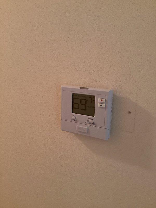 Responded to service call for non-functioning thermostat. Upon arrival, found Badger brand programmable thermostat displaying 59°F with system set to cooling mode in manual operation. Inspected unit, verified display functionality, and assessed thermostat programming and wiring connections to restore proper operation.