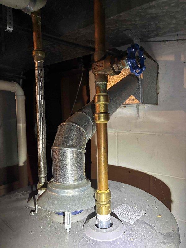 Responded to no hot water call and performed comprehensive assessment of existing gas-fired water heater system. Documented current installation including copper supply piping, braided stainless steel flex connectors, gas line configuration with yellow CSST, and exhaust venting. Observed corrosion and discoloration on pipe fittings and connections indicating age-related deterioration. Evaluated all plumbing connections, gas supply components, and venting system. Provided detailed estimate for complete water heater replacement including removal of existing unit and installation of new equipment with necessary code-compliant connections.