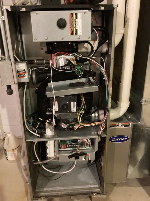 Performed comprehensive tune-up and safety inspection on Carrier furnace unit. Conducted combustion analysis using Testo 310 analyzer, confirming optimal performance with oxygen levels at 94.0%, carbon monoxide at 12.0 ppm, carbon dioxide at 9%, and system efficiency at 93.8%. Inspected all internal components including control board, burner assembly, heat exchanger, electrical connections, and wiring harnesses, finding all systems operating within manufacturer specifications with normal wear patterns and no safety concerns identified.