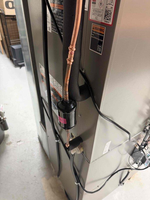 Completed full HVAC system installation including new furnace and air conditioning unit in interior utility space. Installed air handler with proper refrigerant line routing using copper tubing and filter-drier component, secured all electrical connections with appropriate cable management. Post-installation callback addressed reported natural gas odor in equipment room and air handler operating independently of furnace. Performed system diagnostics, verified all gas connections for leaks, inspected thermostat wiring and control circuits to resolve improper equipment cycling. Ensured condensate drainage system properly connected to floor drain. All equipment installed per manufacturer specifications with professional routing of refrigerant lines and electrical conduit. System tested and verified for proper operation of both heating and cooling components.