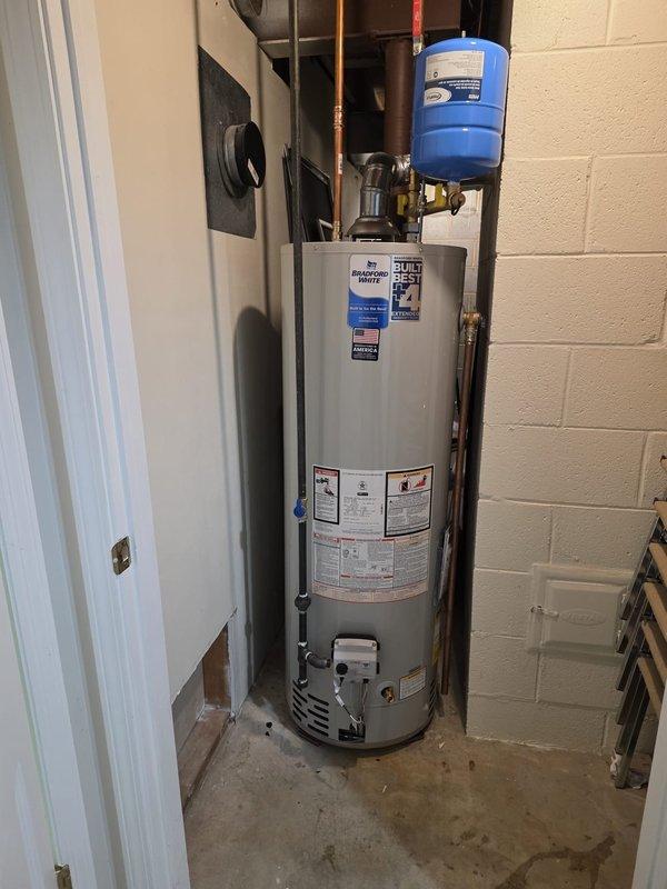 Completed full HVAC system installation including furnace, air conditioning unit, humidifier, and Bradford White water heater. All work performed with proper permitting and licensed electrician coordination. Water heater installation includes proper venting, copper supply lines, expansion tank mounting, and code-compliant pressure relief valve configuration. System installed in utility area with professional plumbing connections and manufacturer warranty documentation provided.