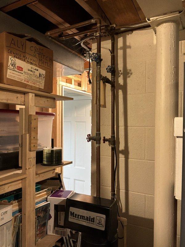Conducted plumbing estimate for reverse osmosis system installation in basement utility area where customer was having new furnace, air conditioning unit, and water heater installed. Assessed existing copper water supply piping with shutoff valves and evaluated PVC drain line configuration to determine optimal placement and connection points for RO system. Documented current plumbing infrastructure including water supply lines, drainage routing, and available space near existing mechanical equipment to provide comprehensive estimate for system installation.