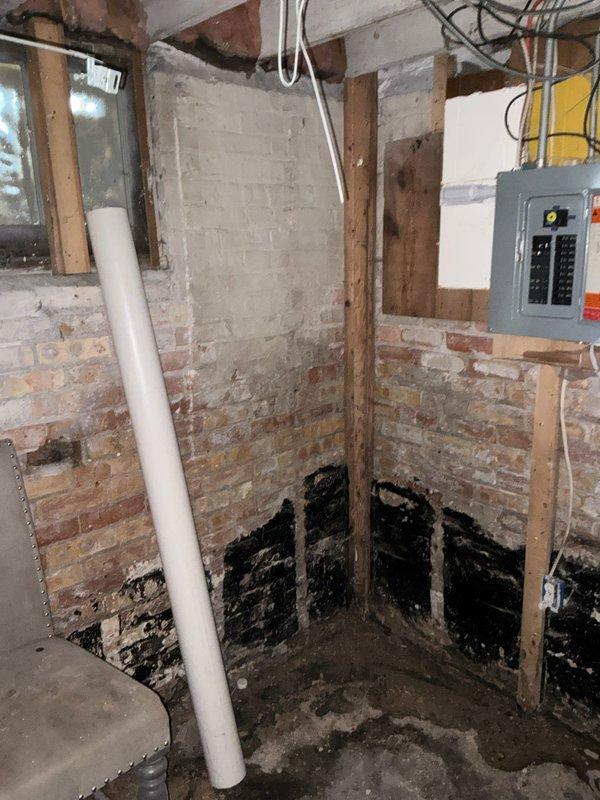 Conducted comprehensive plumbing assessment for sump pump installation in basement area showing significant moisture damage and water staining along walls and floor. Property currently enrolled in municipal pump program with no existing sump crock present. Evaluated unfinished basement space with exposed brick walls, concrete flooring, and visible water damage indicators including dark staining at base of walls and floor discoloration. Prepared complete estimate covering installation of new sump crock and pump system to address drainage concerns and prevent further water intrusion in lower level.
