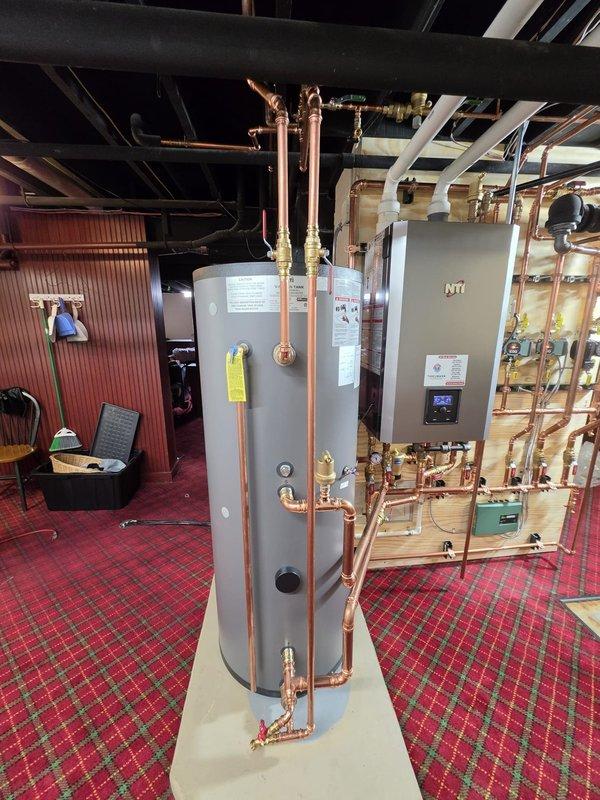 Completed installation of high-efficiency NTI boiler system with indirect-fired water heater in basement mechanical room. All copper piping, valves, and fittings installed per manufacturer specifications with proper venting and circulator pump integration. Installation performed under permit with electrical work coordinated through licensed electrician, ensuring full code compliance and system commissioning.