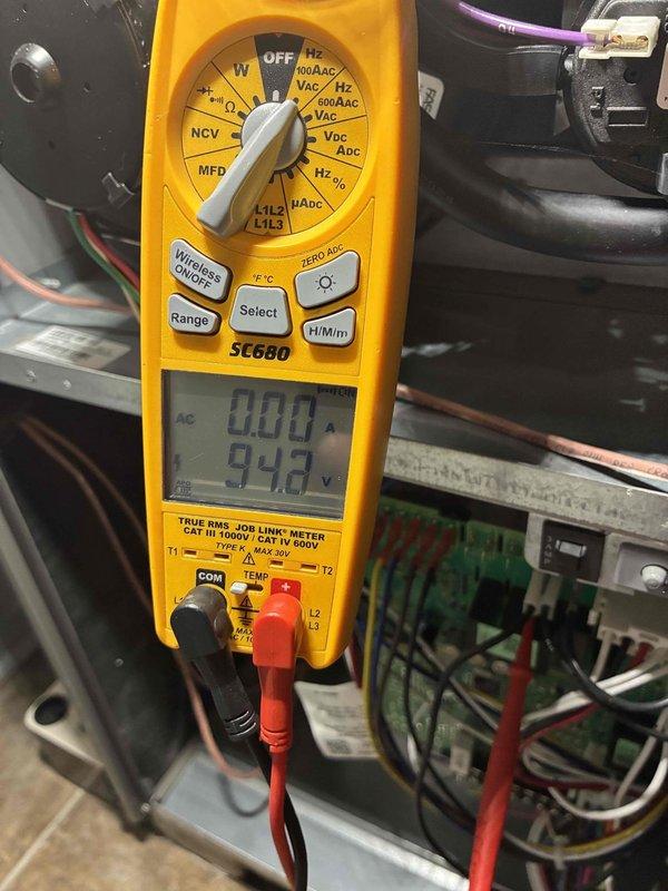 Responded to no heat call on unit displaying E122 error code. Upon arrival, performed diagnostic testing with multimeter which revealed low voltage reading of 94.8V at the control board, indicating a power supply issue. Inspected electrical junction box and control wiring connections. Found loose wire connections at terminal block which were causing intermittent power delivery to the system. Secured all wire connections at terminal block, verified proper wire nut connections, and confirmed all electrical connections were tight and properly seated. Restored power to unit, cleared error code, and verified system operation with proper voltage readings. Unit now heating normally with no error codes present.