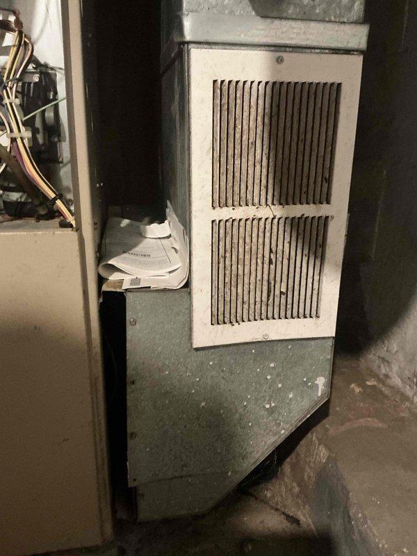 Responded to emergency furnace service request and conducted comprehensive system assessment for replacement estimate. Evaluated existing HVAC equipment in mechanical room, including furnace unit with blower motor assembly, associated ductwork system with flexible and rigid metal components, and refrigerant line configuration. Documented current installation conditions including white metal housing unit with ventilation grilles, copper refrigerant tubing, and green metal base panel for replacement specifications and proposal preparation.
