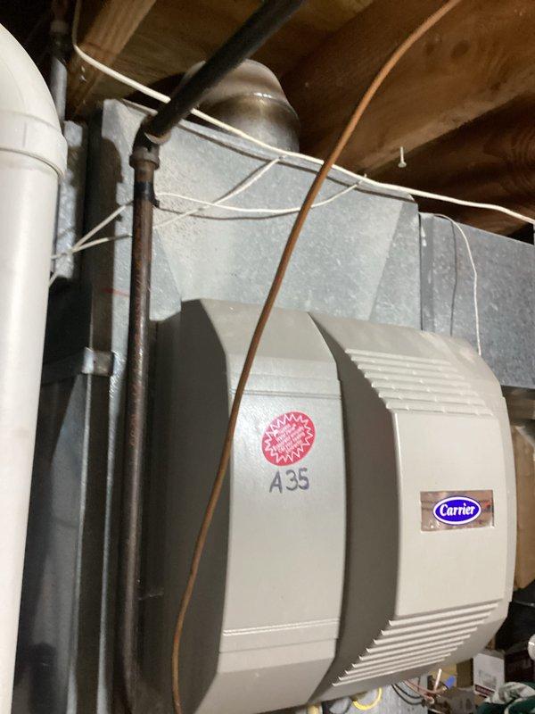 Completed furnace tune-up and system inspection. Serviced Carrier humidifier unit, including replacement of water panel/evaporator pad assembly with brass fittings. Verified proper humidifier operation, checked water supply connection via copper tubing, and confirmed electrical connections to unit mounted on supply ductwork.