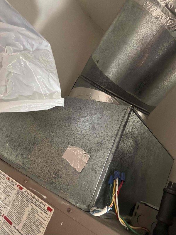 Conducted replacement estimate for 23-year-old Magic Pak packaged HVAC unit in condominium residence. Inspected existing system and ductwork installation in mechanical room, documenting heavy condensation accumulation on plenum and supply duct surfaces indicating potential insulation deficiencies or humidity control issues. Photographed unit configuration, electrical connections, and moisture conditions to provide comprehensive assessment for replacement recommendations.