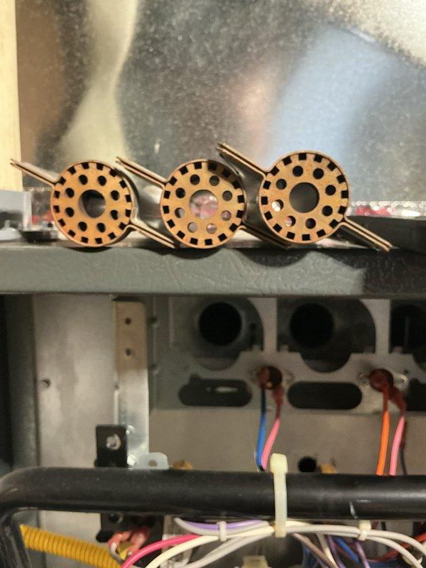 Completed full tune-up maintenance on HVAC system including inspection of control board, wiring harness connections, and reversing valve assembly. Verified all electrical connections secure, checked refrigerant circuit components for proper operation, and documented system condition with interior cabinet photography showing copper reversing valve solenoids and control board in good working order.