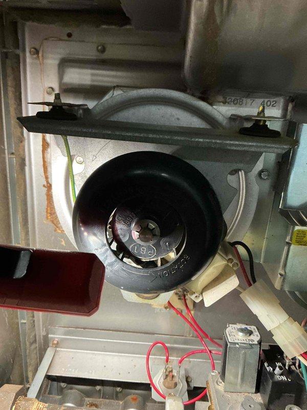 Completed preventative maintenance tune-up on HVAC system. Inspected blower motor assembly, electrical connections, capacitor, and wiring harness; verified all components operating within normal parameters. Documented equipment condition with interior component photography showing motor housing, ductwork connections, and electrical system intact with no immediate service needs identified.